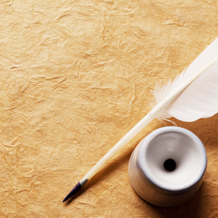 Inkwell and feather on a background of the empty form for the letter