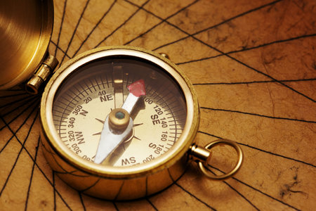 Close up view of the compass on old paper