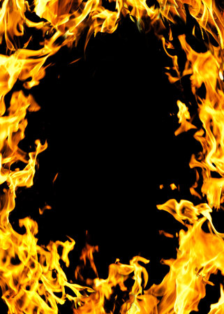 The close-up of yellow fire and dark as a backgroun