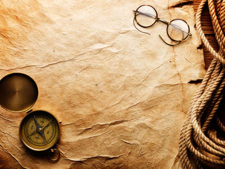 Compass, rope and glasses on old paperの写真素材