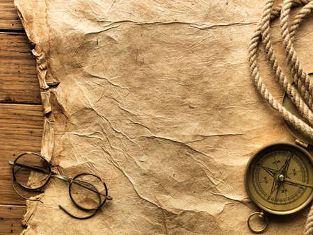 Compass, rope and glasses on old paperの写真素材