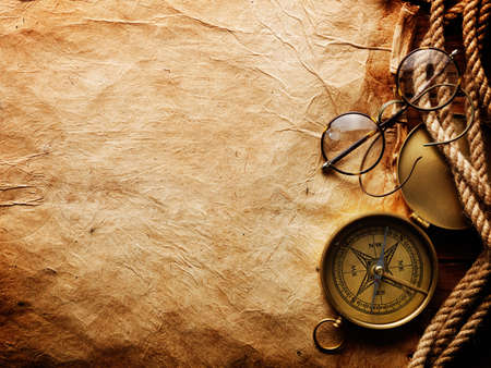 Compass, rope and glasses on old paperの写真素材