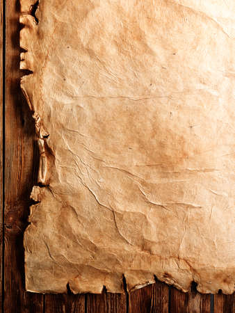 Old paper on brown wood boardの写真素材