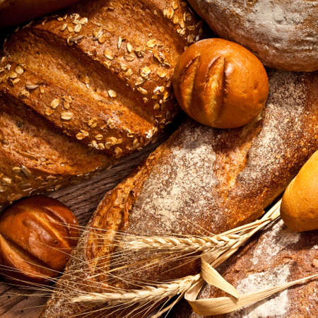 assortment of baked bread on wood tableの写真素材