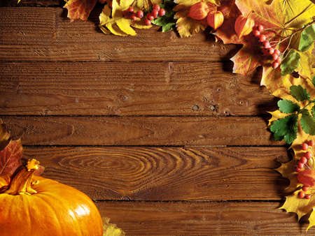 autumn background with colored leaves on wooden boardの写真素材