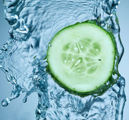 cucumber in spray of water. Juicy cucumber with splash on backgroundの写真素材