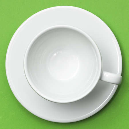 Empty white cup on green placemat. Above view. Isolated on white backgroundの写真素材