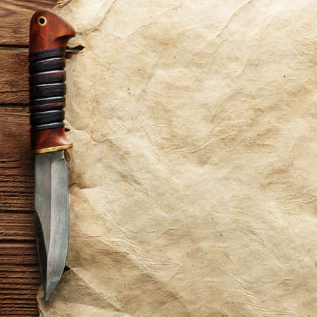 Close up view of knife on vintage paperの写真素材