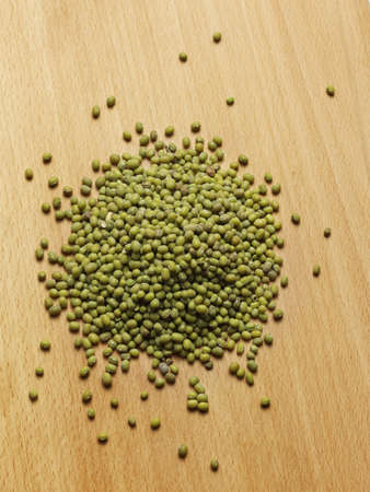 close up view of mung beans on wooden boardの写真素材
