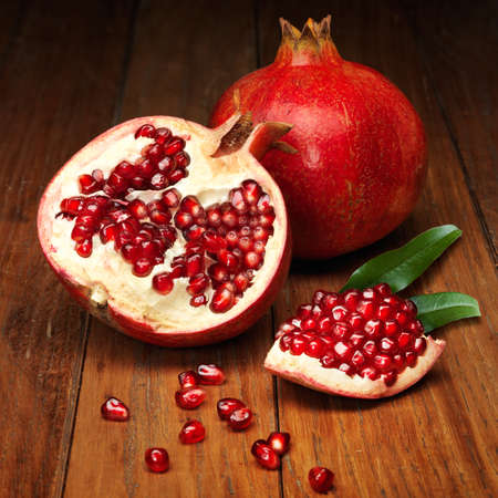 juicy pomegranate open on wood boardの写真素材
