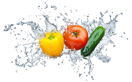 Juicy tomato, cucumber, pepper in spray of water  の写真素材