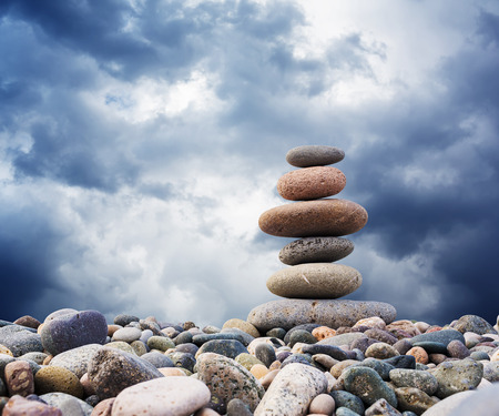 Zen Stones balance, pebbles stack over blue seaの写真素材