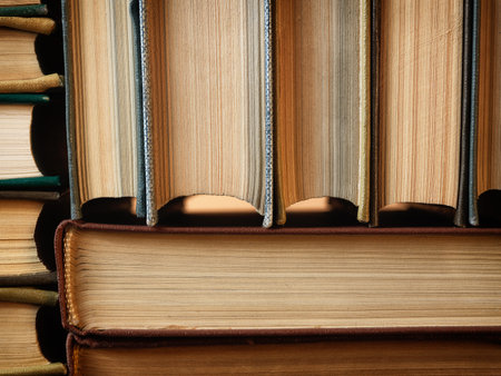 Concept background made of old books arranged in well-ordered close stacks