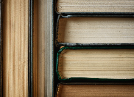 Concept background made of old books arranged in well-ordered close stacksの写真素材