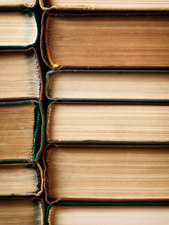 Concept background made of old books arranged in well-ordered close stacksの写真素材