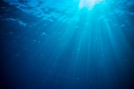abstract underwater scene sunrays and air bubbles in deep blue sea