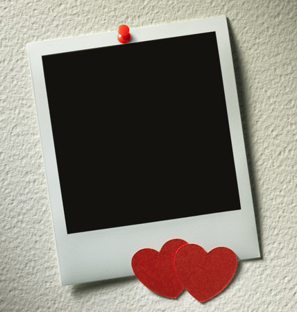 polaroid style photo frames on paper background with paper heartの写真素材