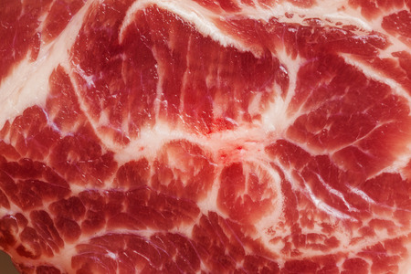 Background texture of uncooked marbled fatty meat for use as a cooking ingredient for dinnerの写真素材
