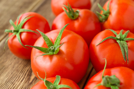 Close-up of fresh, ripe tomatoes on wood backgroundの写真素材