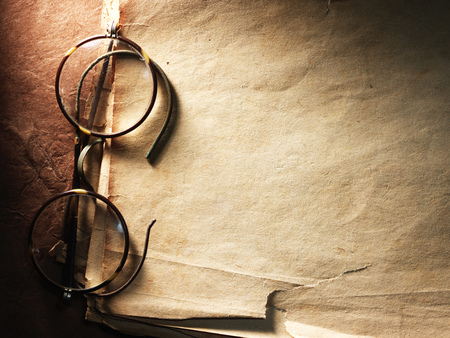 Vintage glasses on the very old paperの写真素材