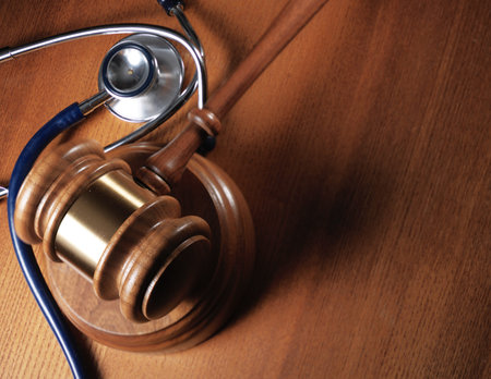 Judge gavel and stetaskop on wooden background. Close upの写真素材