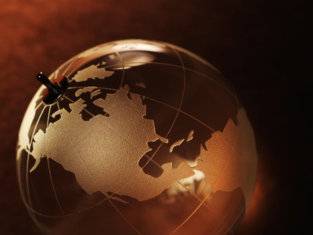 glass ball with a picture of a world map on vintage paper backgroundの写真素材