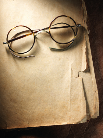 Vintage glasses on the very old paperの写真素材
