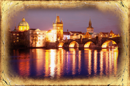 View of the Lesser Bridge Tower of Charles Bridge in Prague (Karluv Most) the Czech Republic. This bridge is the oldest in the city and a very popular tourist attraction.Filtered image: vintage effect.の写真素材
