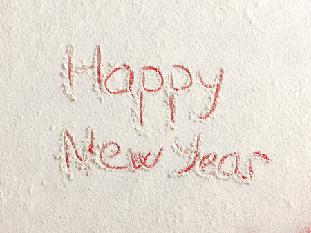 Happy New Year written on white snow. Christmas card.