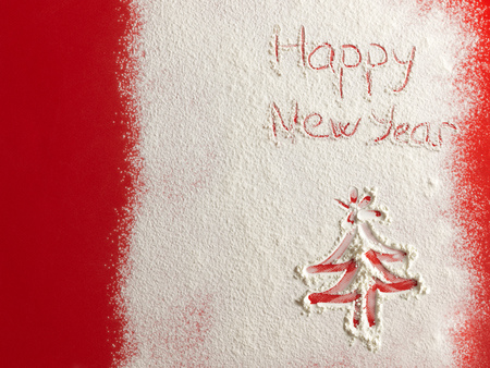 Happy New Year written on white snow. Christmas card.の写真素材