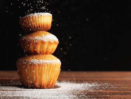 Christmas muffins covered powdered sugar, background for congratulationsの写真素材