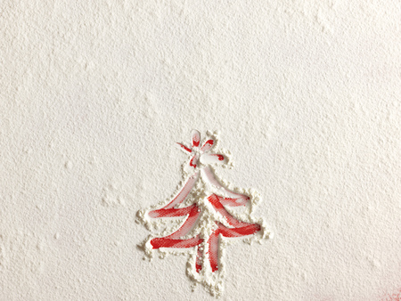 Christmas tree on flour background. White flour looks like snow. Top viewの写真素材