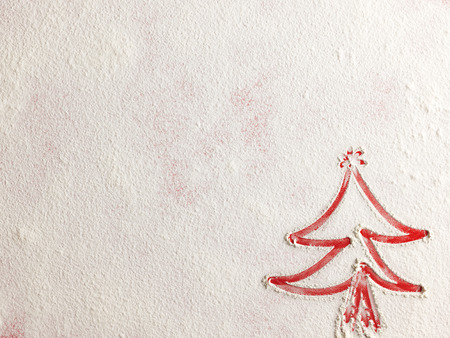 Christmas tree on flour background. White flour looks like snow. Top viewの写真素材
