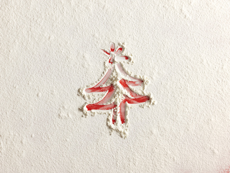 Christmas tree on flour background. White flour looks like snow. Top viewの写真素材
