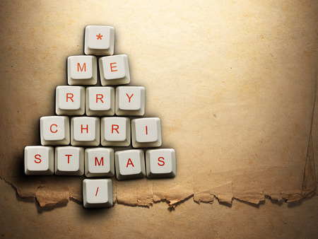 Christmas card - Christmas tree made of computer keys, Old paper backgroundの写真素材