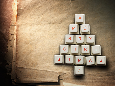 Christmas card - Christmas tree made of computer keys, Old paper backgroundの写真素材