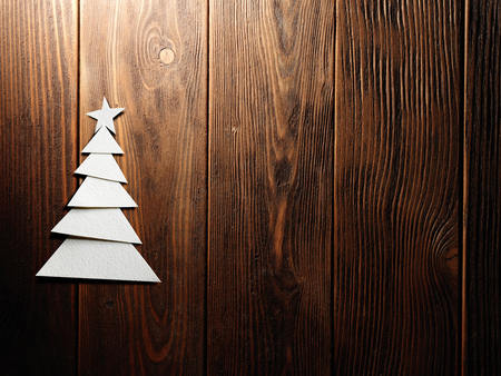 Christmas tree cut out from paper on a wooden backgroundの写真素材