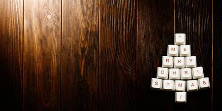 Christmas card - Christmas tree made of computer keys, tree background with vignetteの写真素材