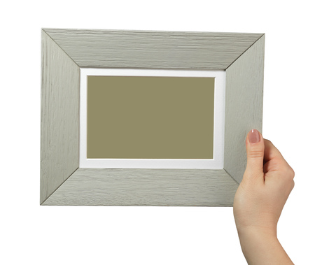 female hand holding a wooden frame isolated on white background. close upの写真素材
