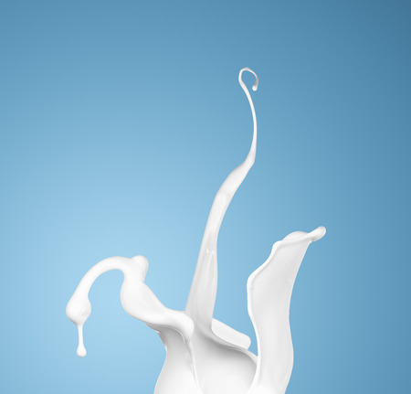 milk or white liquid splash on blue background. isolatedの写真素材
