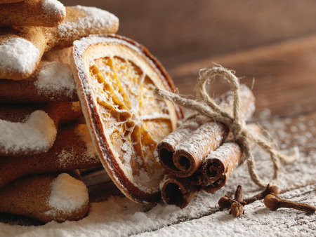 Christmas gingerbread cookies and spices on wooden background. Close-upの写真素材