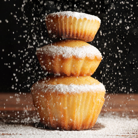 Christmas muffins covered powdered sugar, (background for congratulations)の写真素材