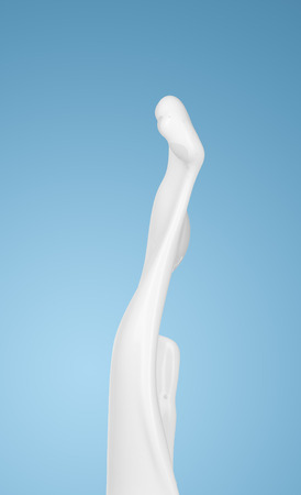 milk or white liquid splash on blue background. isolatedの写真素材