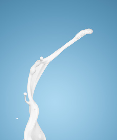 milk or white liquid splash on blue background. isolatedの写真素材