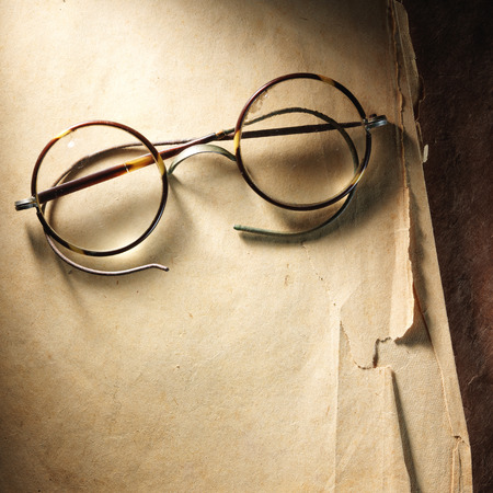 Vintage glasses on the very old paperの写真素材