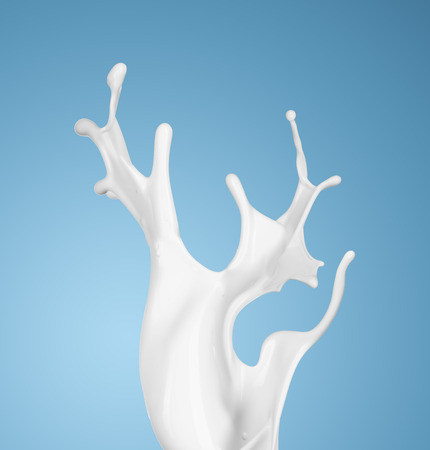 milk or white liquid splash on blue background. isolatedの写真素材