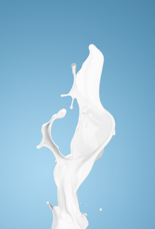milk or white liquid splash on blue background. isolatedの写真素材
