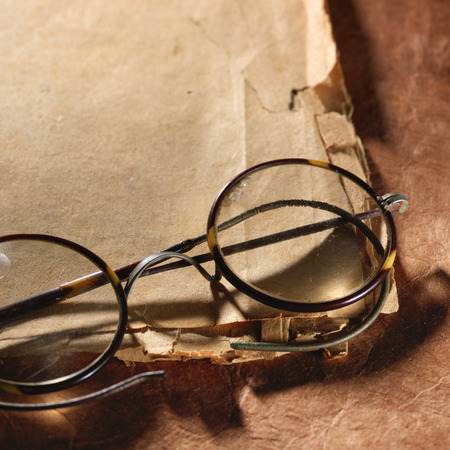 Vintage glasses on the very old paperの写真素材