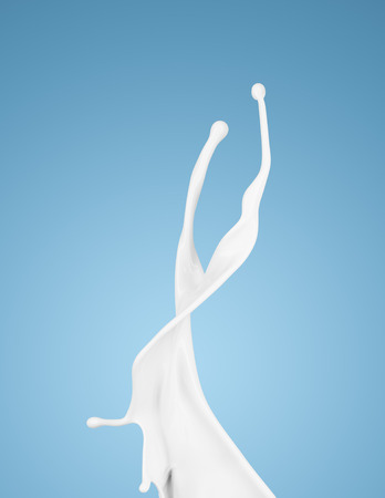 milk or white liquid splash on blue background. isolatedの写真素材