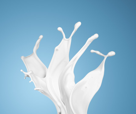 milk or white liquid splash on blue background. isolatedの写真素材